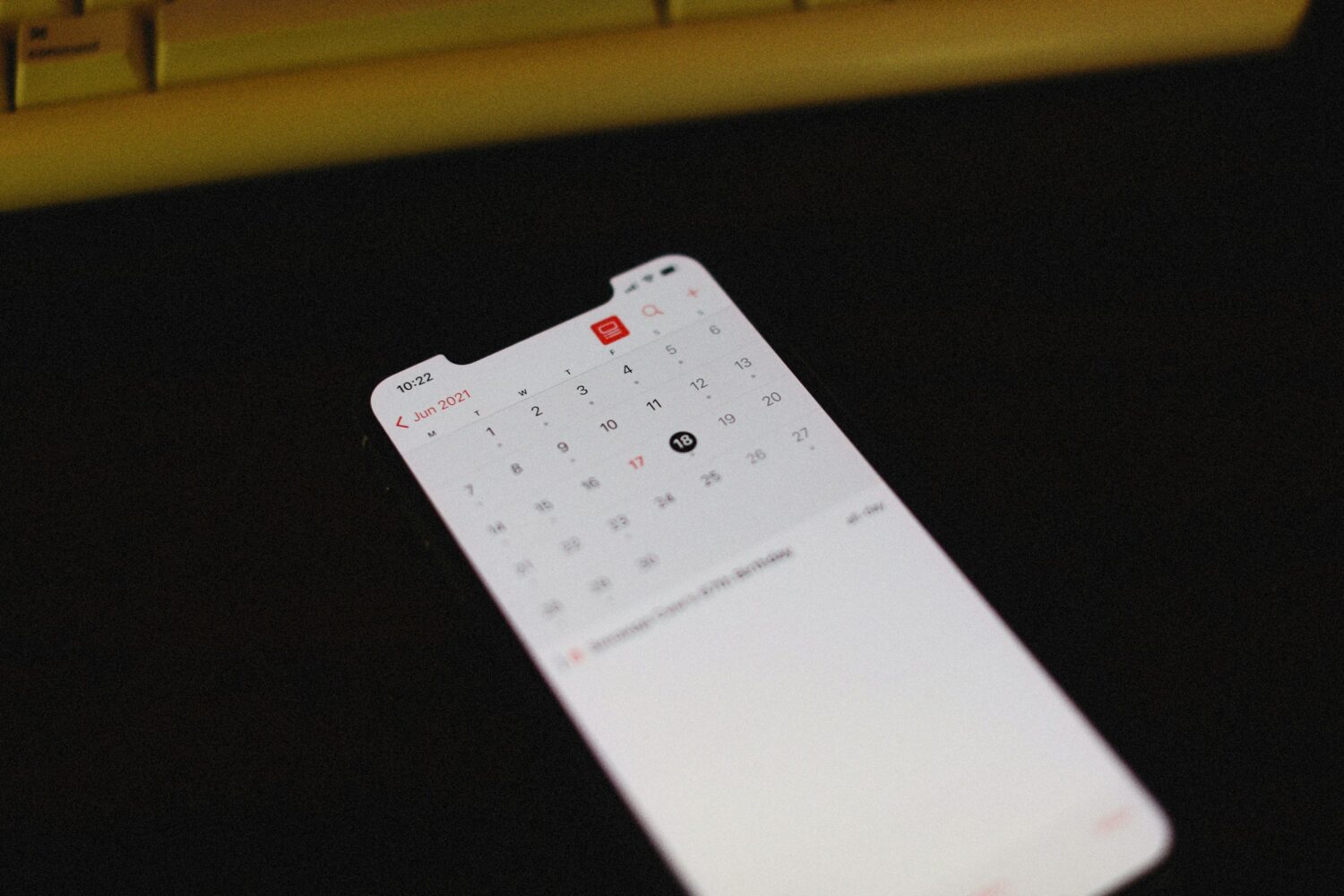 a close up of a keyboard with a calendar on it